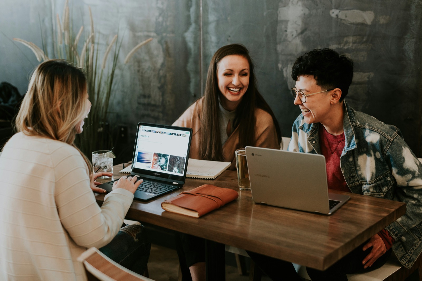 Friends reviewing investments together on a laptop