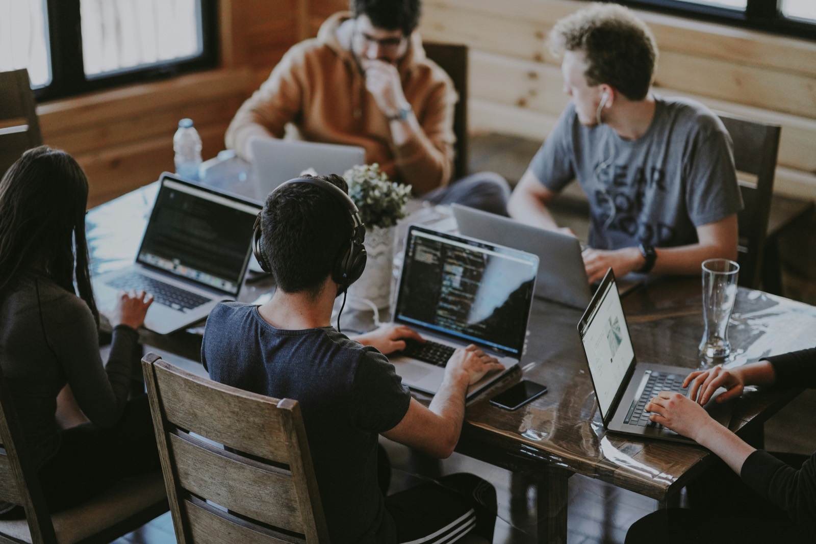 A team working with laptops around a table